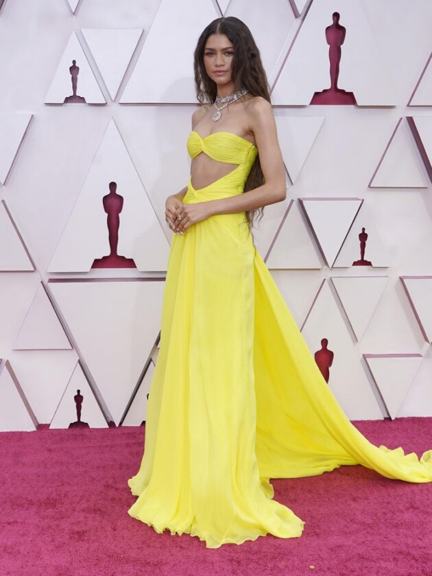 As principais tendências do tapete vermelho do Oscar 2021 zendaya de vestido amarelo longo na frente do backdrop do oscar