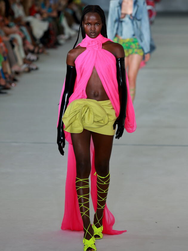 As principais tendências de minissaia da temporada Tendências de minissaia: saias com aplicações de flores aparecem no desfile de verão 2023 de Prabal Gurung. Aqui, modelo usa saia verde curta com grande flor